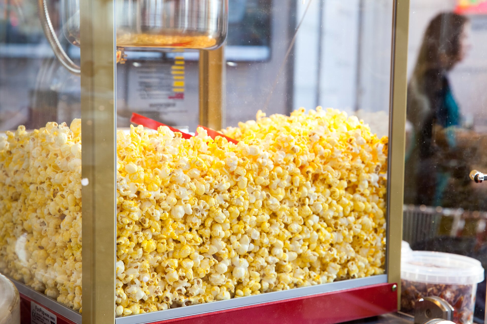 Commercial popcorn machine filled with popcorn