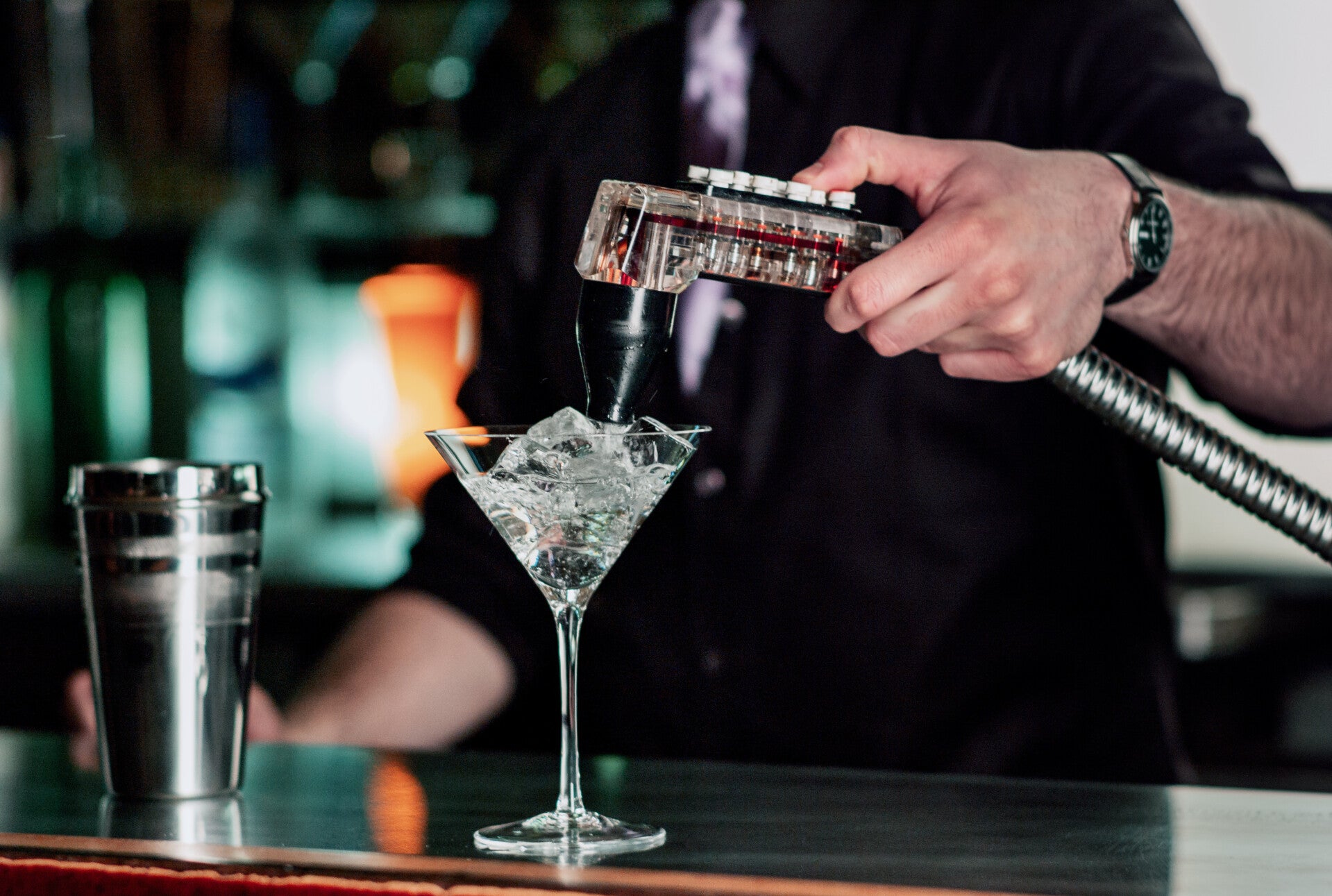 Bartender dispensing soda from a bar gun
